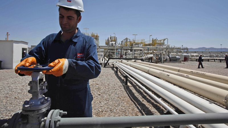 In this May 31, 2009 file photo, an employee works at theTawke oil fields in the semiautonomous Kurdish region in northern Iraq. (AP Photo/Hadi Mizban, File)