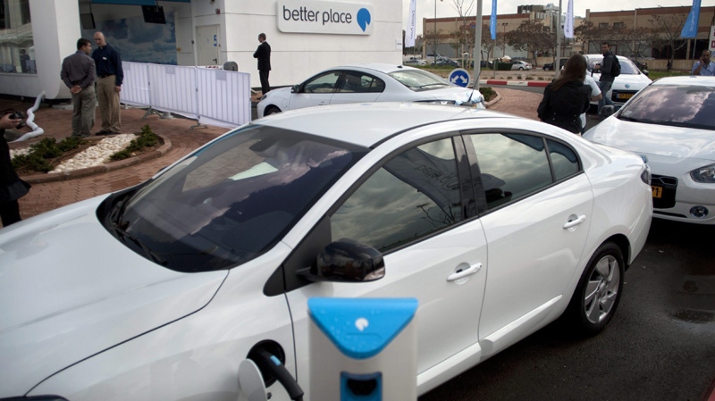 A car is connected to a battery switch station of "Better Place", a project developing electric vehicles and a network of charging points, in Kiryat Ekron, central Israel, Wednesday, March 23 , 2011.(AP Photo/Sebastian Scheiner)