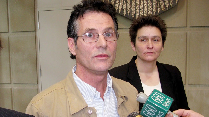 David Milgaard, accompanied by a court worker, right, speaks briefly with reporters at the Calgary Courts Centre, Monday, Nov. 14, 2011. (Bill Graveland / THE CANADIAN PRESS)