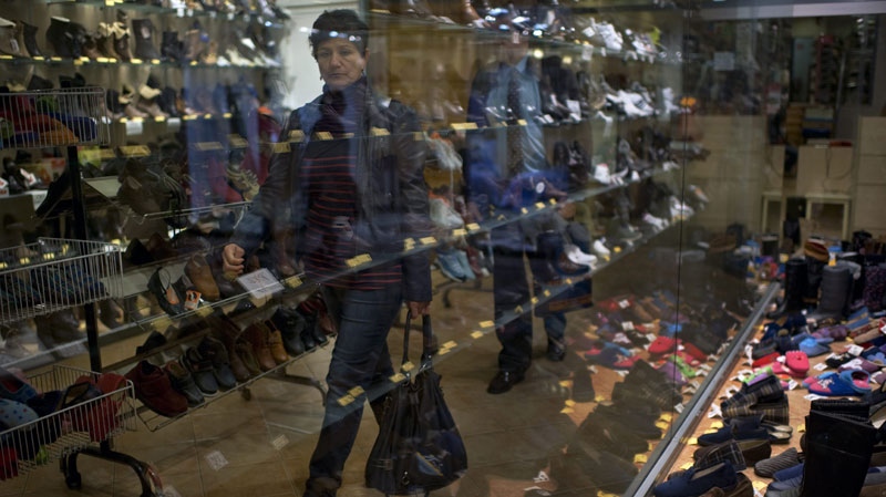 A woman passes in front of a shoe shop in Pamplona, Spain, on Nov. 14, 2011