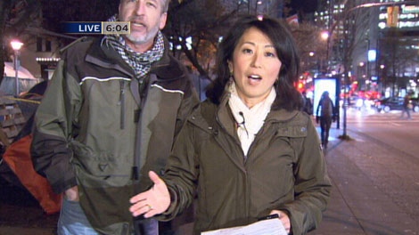 A protester interrupts CTV British Columbia's Mi-Jung Lee while she reports from the Occupy Vancouver tent city. Nov. 15, 2011. (CTV)