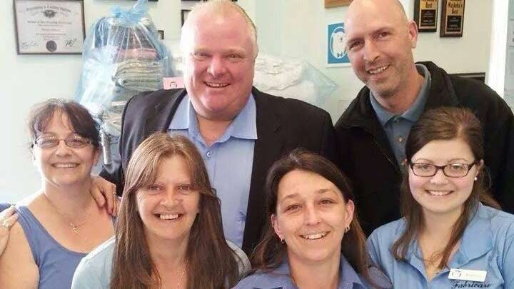 Rob Ford (top left) poses with staff at Fabricare in Gravenhurst, Ont., Friday, May 16, 2014. (Erin Strenghth / Facebook)