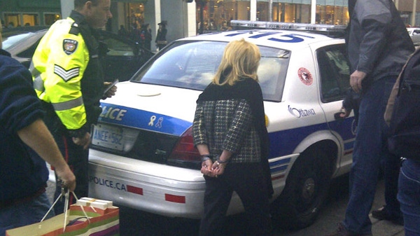 Christy Natsis is seen being led out of the Rideau Centre in handcuffs Thursday, Nov. 17, 2011.