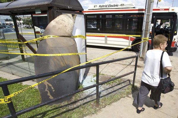 A piece of steel weighing hundreds of pounds, that was blown over 500 metres from the site of the explosion, sits embedded in a bus shelter in Toronto on Monday August 11, 2008. (Frank Gunn / THE CANADIAN PRESS)