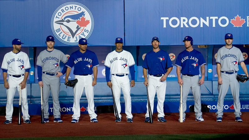 The Toronto Blue Jays players pictures left to right, Jose Bautista, Adam Lind, Ricky Romero, J.P. Arencibia, Yunel Escobar, Brett Lawrie, Brandon Morrow show off the team's new uniforms, a familiar look that connects the past with the future, in Toronto on Friday, Nov. 18, 2011.  (Nathan Denette / THE CANADIAN PRESS)