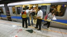 Officials block parts of the scene of a knife attack on a subway platform, in Taipei, Taiwan, Wednesday, May 21, 2014. (AP Photo)