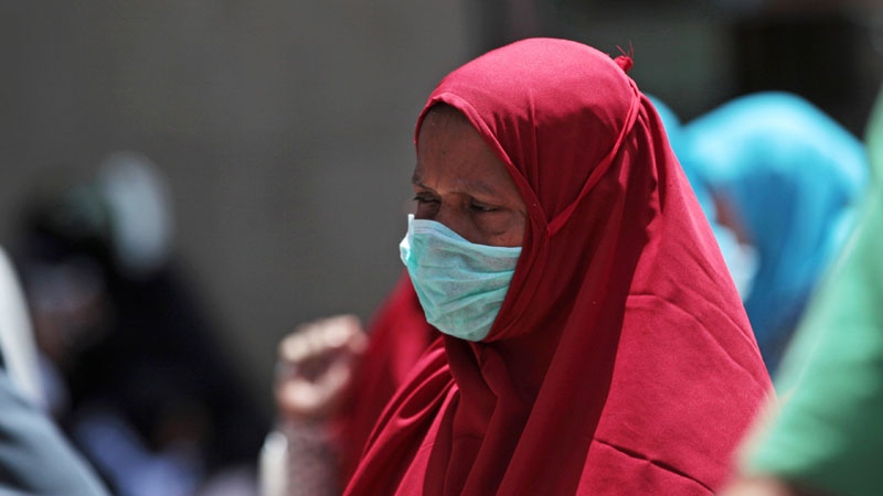 A Muslim pilgrim wears a mask to prevent MERS