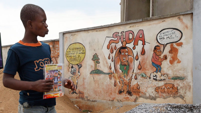 A child walks past graffiti warning citizens to protect themselves from HIV and AIDS in Yaounde, Cameroon, Tuesday, Oct. 11. 2011. (AP / Sunday Alamba)