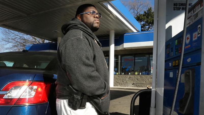 Man wears a gun while pumping gas in Detroit