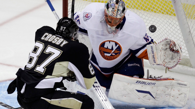 Pittsburgh Penguins' Sidney Crosby, 87, scores a first-period goal over New York Islanders goalie Anders Nilsson during an NHL hockey game in Pittsburgh on Monday, Nov. 21, 2011. (AP / Gene J. Puskar)