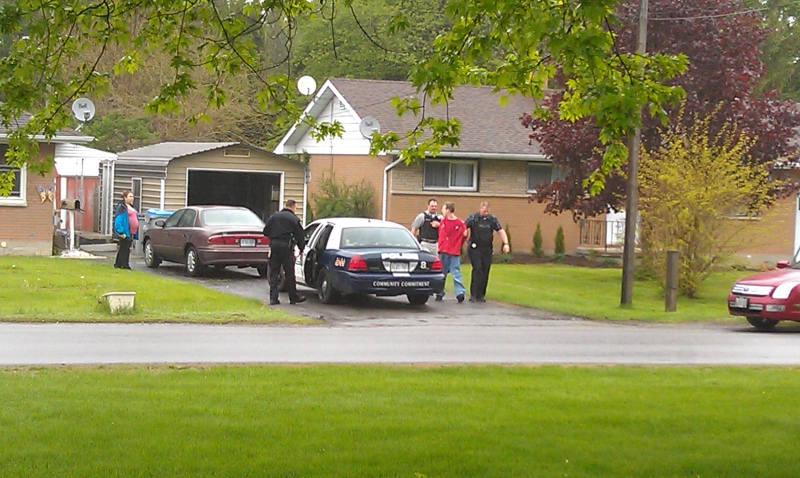 A male, second from right, is arrested by police in Stathroy, Ont. on Friday, May  23, 2014. (Viewer submitted photo.)