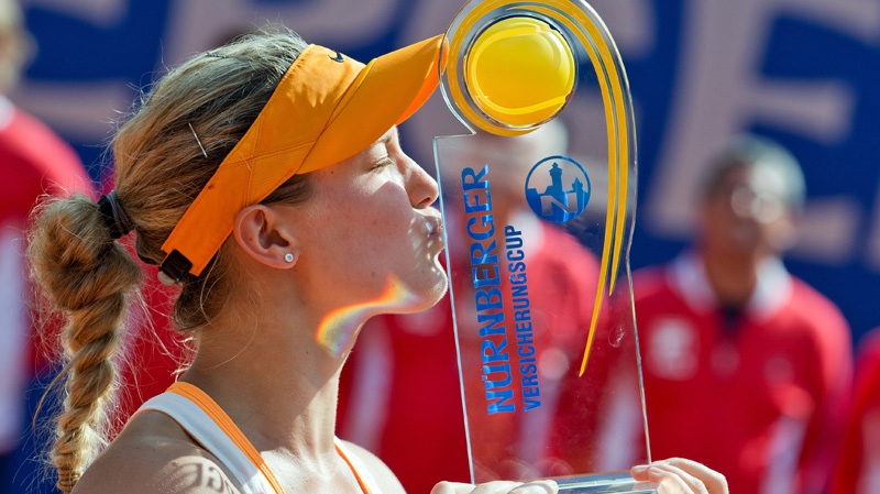 Canadian Eugenie Bouchard kisses the trophy after 