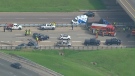 Emergency crews tend to the scene of a crash on the ramp from Highway 401 eastbound and Highway 427 southbound to Eglinton Avenue in Toronto on Thursday morning, May 29, 2014.
