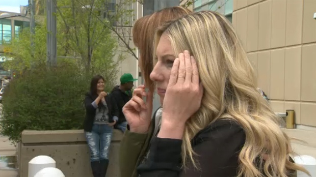 Amie Nottebrock attempts to conceal her face outside of the Calgary Courts Centre on May 29, 2014