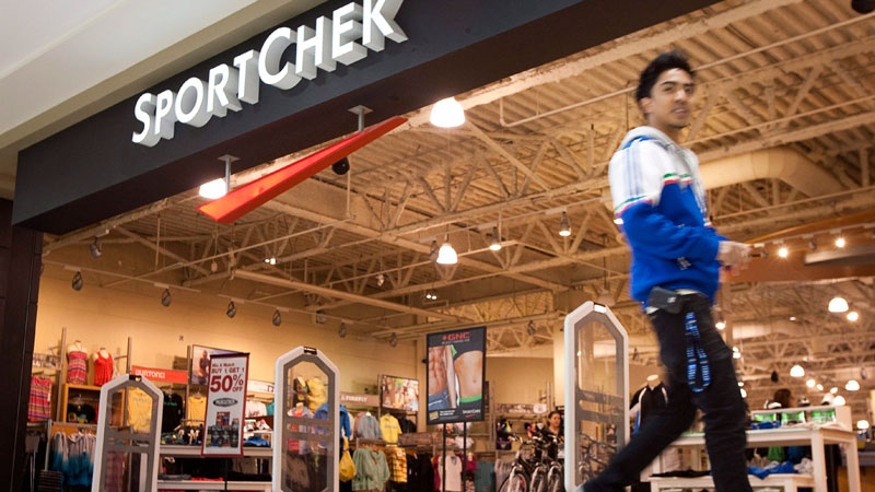 A shopper walks past a Sport Chek store in Calgary