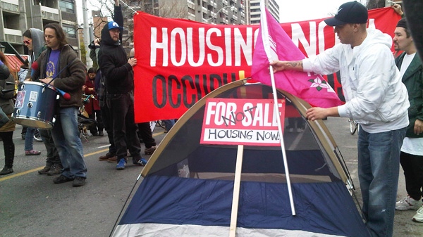 A handful of Occupy Toronto protestors, calling for increases to public services and housing, set up a tent briefly on Sherbourne Street on Saturday, Nov. 26, 2011 (Colin D'Mello/CTV News)