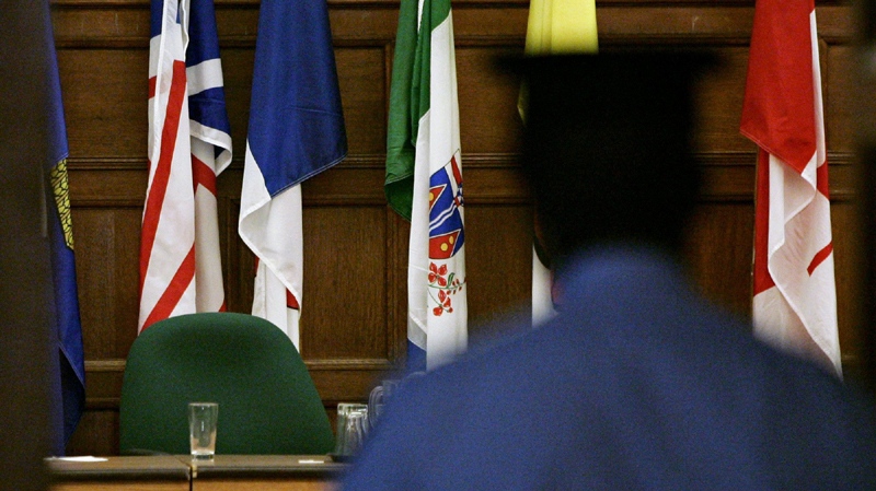 A House of Commons security guard walks into the empty government caucus room on Parliament Hill in Ottawa Wednesday May 17, 2006. 