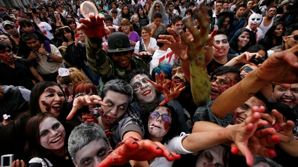 People dressed as zombies react to the camera during the V edition of the so-called 'Zombie Walk' in Mexico City, Saturday, Nov. 26, 2011. (AP / Marco Ugarte)