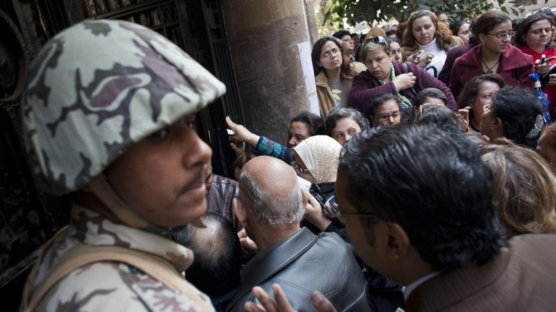 An Egyptian Army soldier stands guard as voters enter a polling centre in Cairo, Egypt, Monday, Nov. 28, 2011.