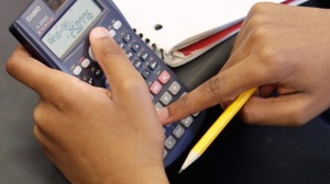 In this photo taken Tuesday, April 21, 2009, sixth-grader Jabarie Barnes uses a calculator in his personal finance class at Ariel Community Academy on Chicago's South Side.  (AP / Charles Rex Arbogast)