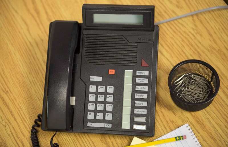 A telephone sits on a desk in a Toronto office on Friday, May 16, 2014. (THE CANADIAN PRESS)