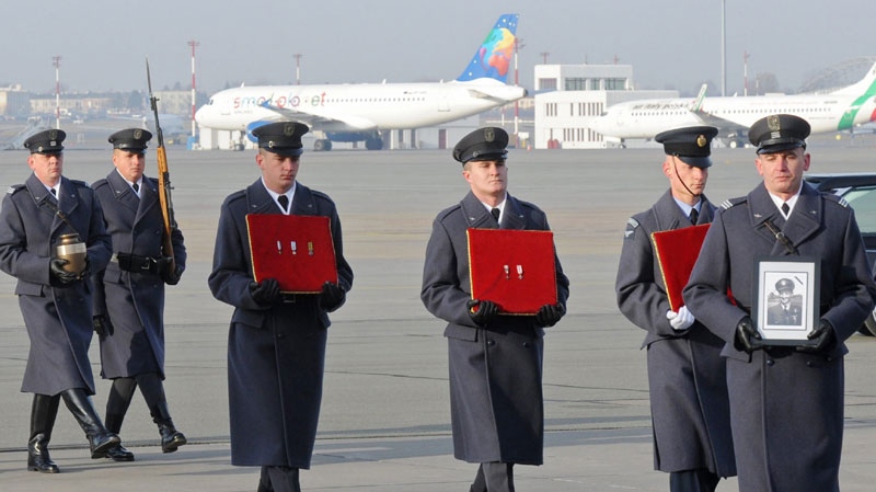 Polish Air Firce and Royal Air Force soldiers carry the ashes and medals of Gen. Tadeusz Sawicz, the last surviving Polish pilot from the 1940 Battle of Britain, during the arrival ceremony at the military airport in Warsaw, Poland, Tuesday, Nov. 29, 2011.