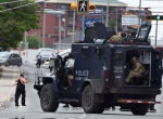 A nerve-wracking manhunt came to an end early Friday morning after police apprehended the suspect wanted in one of the worst mass shootings in the RCMP's history that left three Mounties dead and two others wounded in Moncton.<br><br>A resident of a boarding house is evacuated by emergency response officers as they search a building in Moncton, N.B. on Thursday, June 5, 2014. (Andrew Vaughan / THE CANADIAN PRESS)