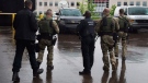 Police officers head from the court appearance of Justin Bourque, the suspect in one of the worst mass shootings in the RCMP's history, in Moncton, N.B. on Friday, June 6, 2014. (Andrew Vaughan / THE CANADIAN PRESS)
