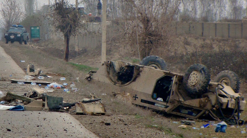A damaged German military armored vehicle with the NATO- led International Security Assistance Force (ISAF) is seen on the ground after it was hit by road side bomb in Baghlan north of Kabul, Afghanistan, Tuesday, Nov. 29, 2011. (AP / Javid Basharat)