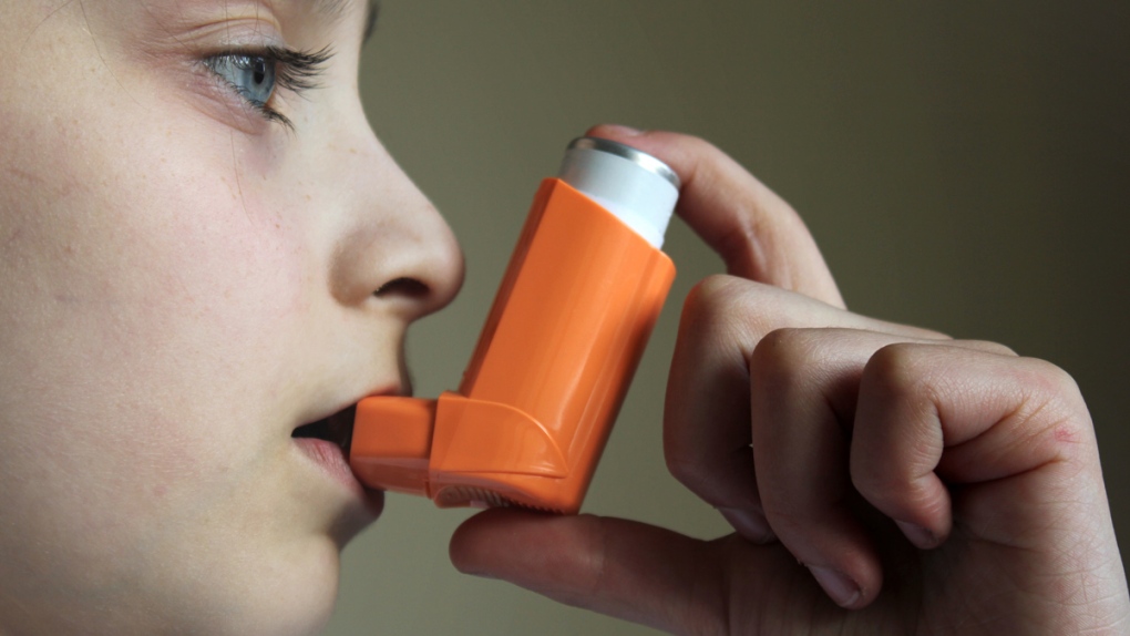 A child uses an inhaler to treat asthma