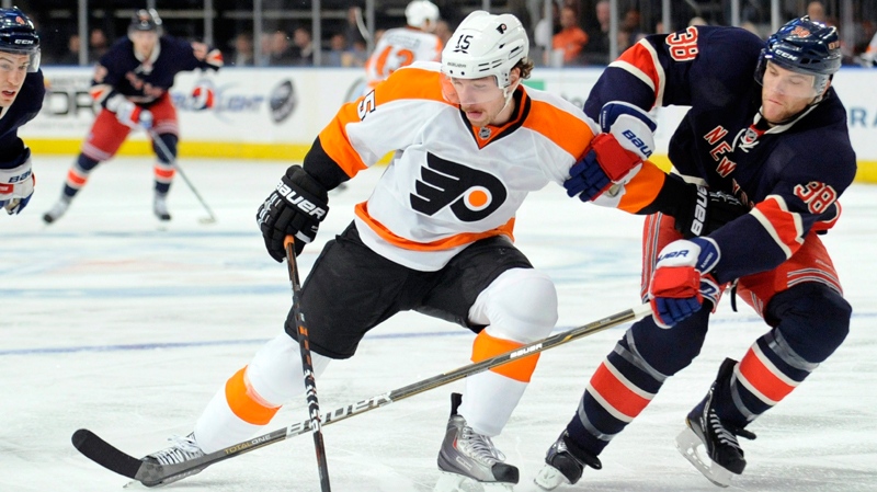 New York Rangers' Michael Sauer, right, pokes the puck away from Philadelphia Flyers' Andreas Nodl, of Austria, during the first period of an NHL hockey game Saturday, Nov. 26, 2011 at Madison Square Garden in New York. (AP / Bill Kostroun)