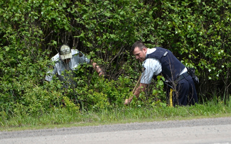 RCMP officers continue to search for evidence in Moncton, N.B. on Monday, June 9, 2014. A regimental funeral will take place Tuesday for the three RCMP officers slain in Moncton last week. (Sean Kilpatrick / THE CANADIAN PRESS)