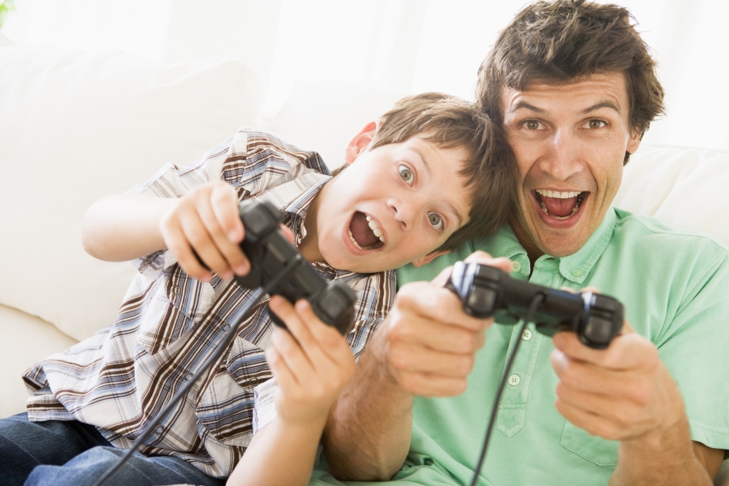 Teen with father - video games