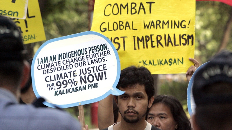 Police block environmental activists as they march during the observance of World Climate Day Saturday, Dec. 3, 2011 near the U.S. Embassy in Manila, Philippines. (AP Photo/Pat Roque)