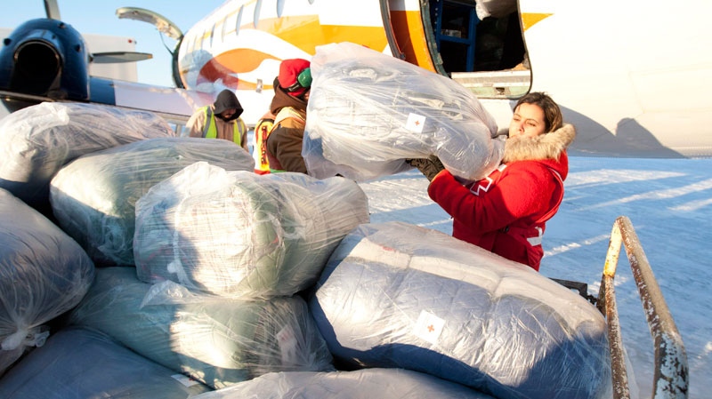 A Red Cross worker loads sleeping bags onto a trailer at the airport in Attawapiskat, Ont., Tuesday November 29, 2011. (Adrian Wyld / THE CANADIAN PRESS)