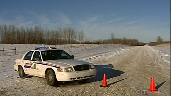 Police are at seen at the scene where two RCMP officers were shot and wounded during a standoff near Breton, Alberta, Sunday, Nov. 4, 2011. 