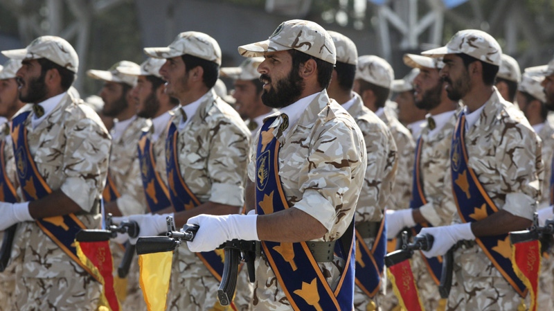 In this Sept. 22, 2011 photo, members of Iran's Revolutionary Guard march in front of the mausoleum of the late Iranian revolutionary founder Ayatollah Khomeini, just outside Tehran, Iran, during armed an forces parade marking the 31st anniversary of the start of the Iraq-Iran war. (Vahid Salemi/AP Photo)