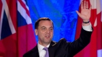 Ontario Progressive Conservative leader Tim Hudak, right, announces that he will be stepping down as party leader after being defeated his election night campaign head quarters as his wife Deb Hutton looks on, in Grimsby, Ont., on Thursday, June 12, 2014. (Nathan Denette / THE CANADIAN PRESS)