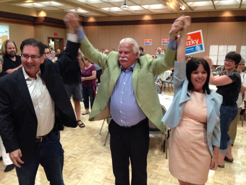 Windsor-Tecumseh's Percy Hatfield and Windsor West's Lisa Gretzky hold their hands high with Windsor West MP Brian Masse, after securing their ridings on Thursday, June 12, 2014. (Sacha Long/ CTV Windsor)
