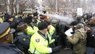 Protesters are pepper sprayed by police at the Congolese embassy Tuesday, Dec. 6, 2011.