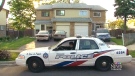 Police are shown outside of a home in northeast Toronto on Saturday, June 7, 2014.