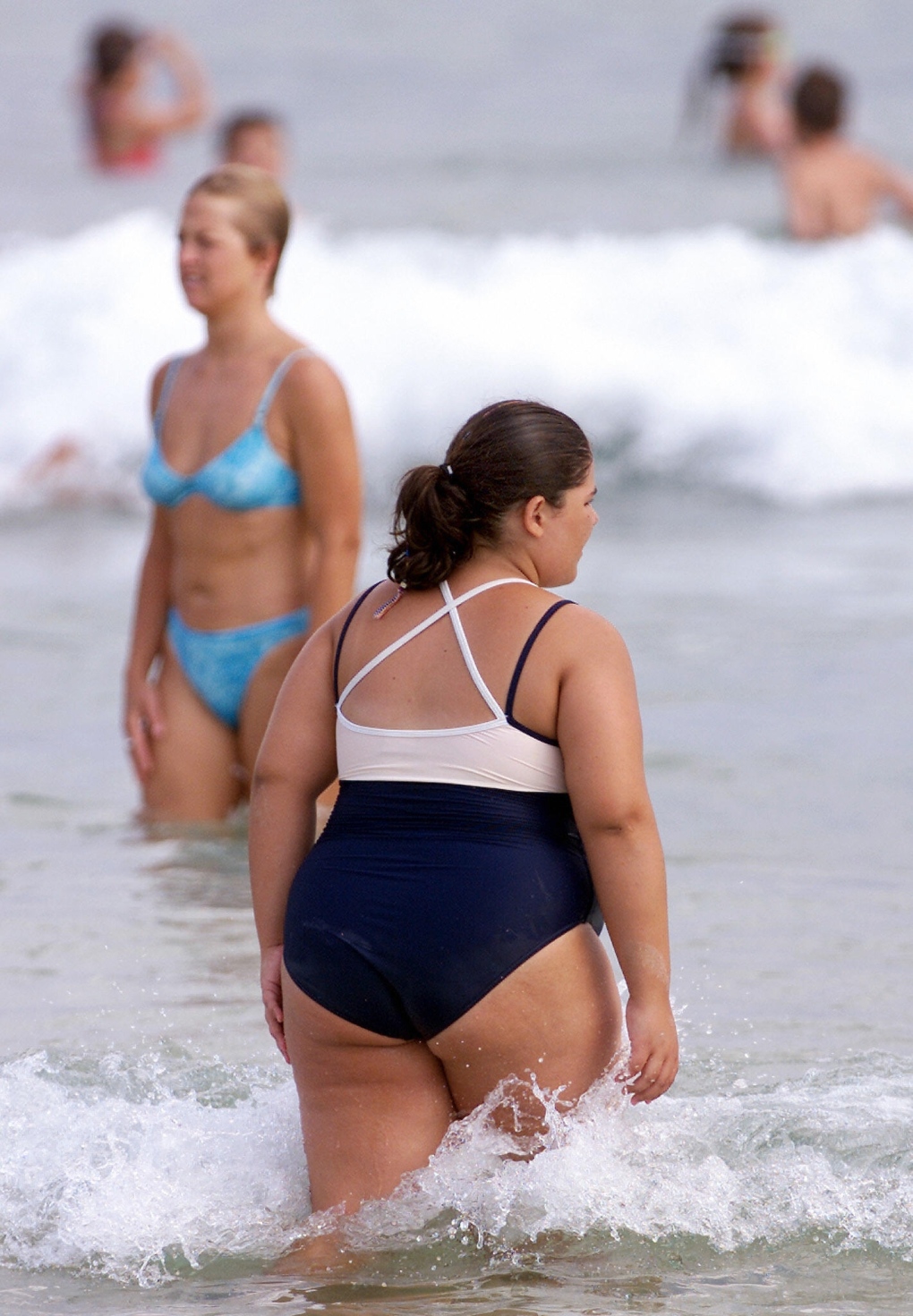 Overweight, obese woman at the beach