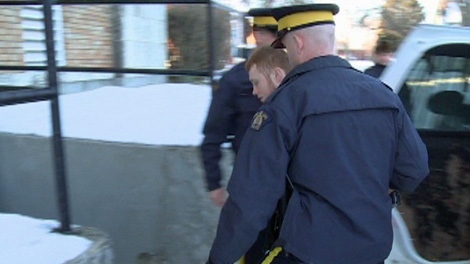 Kyle Furness is escorted to court by RCMP officers in Yorkton on Wednesday.