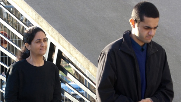 Tooba Mohammad Yahya and Hamed Shafia, right, leave the holding cell at the Frontenac county courthouse in Kingston, Ontario on Thursday Dec. 8, 2011. (Lars Hagberg / THE CANADIAN PRESS)