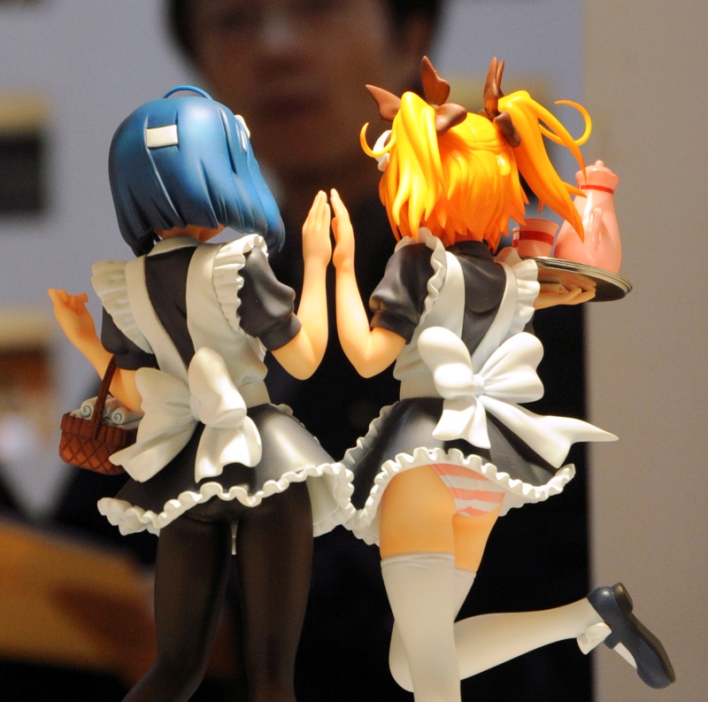 In this May 27, 2008 photo, a visitor to the Tokyo International Anime Fair looks at cartoon figures on display in Tokyo. Japan's parliament has passed a law which bans possession of child pornography, but excludes sexually explicit depictions of children in comics, animation and computer graphics. (AP / Katsumi Kasahara)