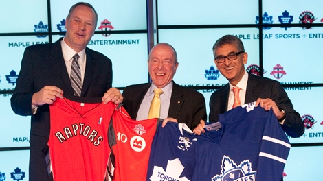 George Cope, president and CEO of Bell (left), MLSE Chairman Larry Tanenbaum (centre) and Nadir Mohamed, president and CEO of Rogers hold up Toronto Raptors, Toronto FC, Toronto Maple Leafs and Toronto Marlies jerseys following a press conference in Toronto on Friday, Dec. 9, 2011. (Chris Young / THE CANADIAN PRESS)  