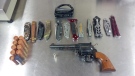 A handgun and prohibited knives seized from a home are seen in this photo released by the London Police Service.