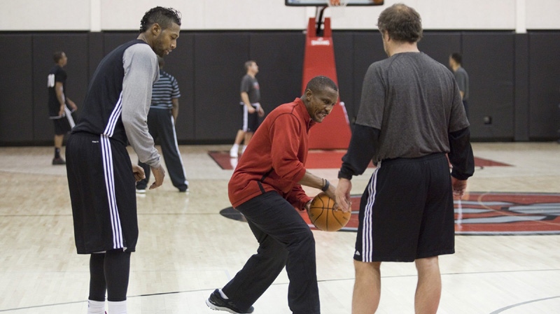 Toronto Raptor James Johnson, left, gets some advice from head coach Dwane Casey, center, and an assistant coach during a team practice at the Air Canada Center in Toronto on Friday, December 9, 2011. 