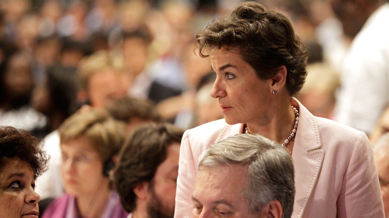 U.N. climate official Christiana Figueres, right, talks with delegates at the climate change summit as it nears it's end in the city of Durban, South Africa, Saturday, Dec. 10, 2011. (AP / Schalk van Zuydam)