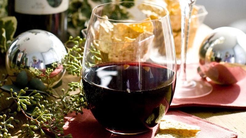 This Nov. 8, 2011 photo shows a glass of red wine in Concord, N.H. The best wines for holiday parties are like good hosts, accommodating enough to handle a variety of scenarios, but with enough personality to keep everyone entertained. (AP Photo/Matthew Mead)